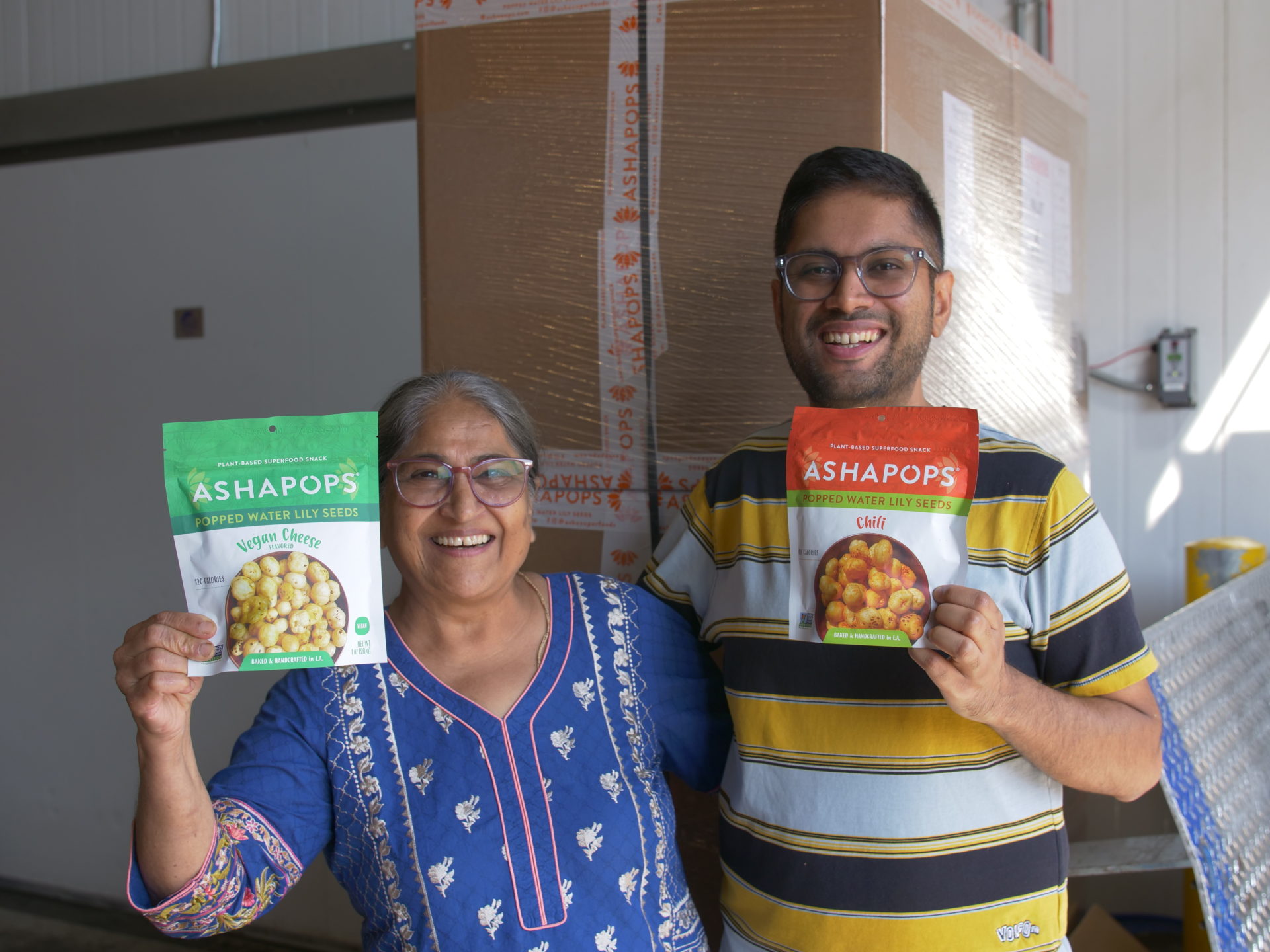 Founders, Jai and Asha, posing with their food product, 